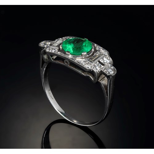 A 1940 platinum ring with diamonds and emerald.